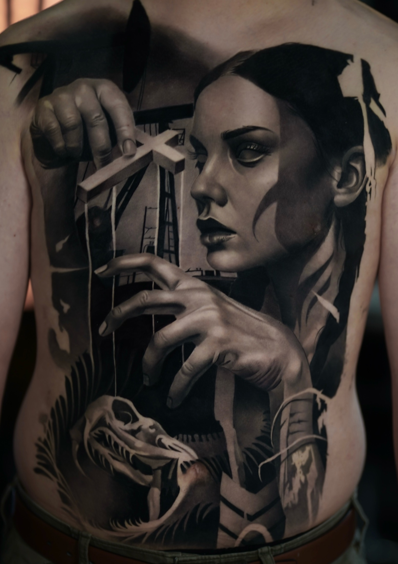 Finished dark realism oil field back tattoo.