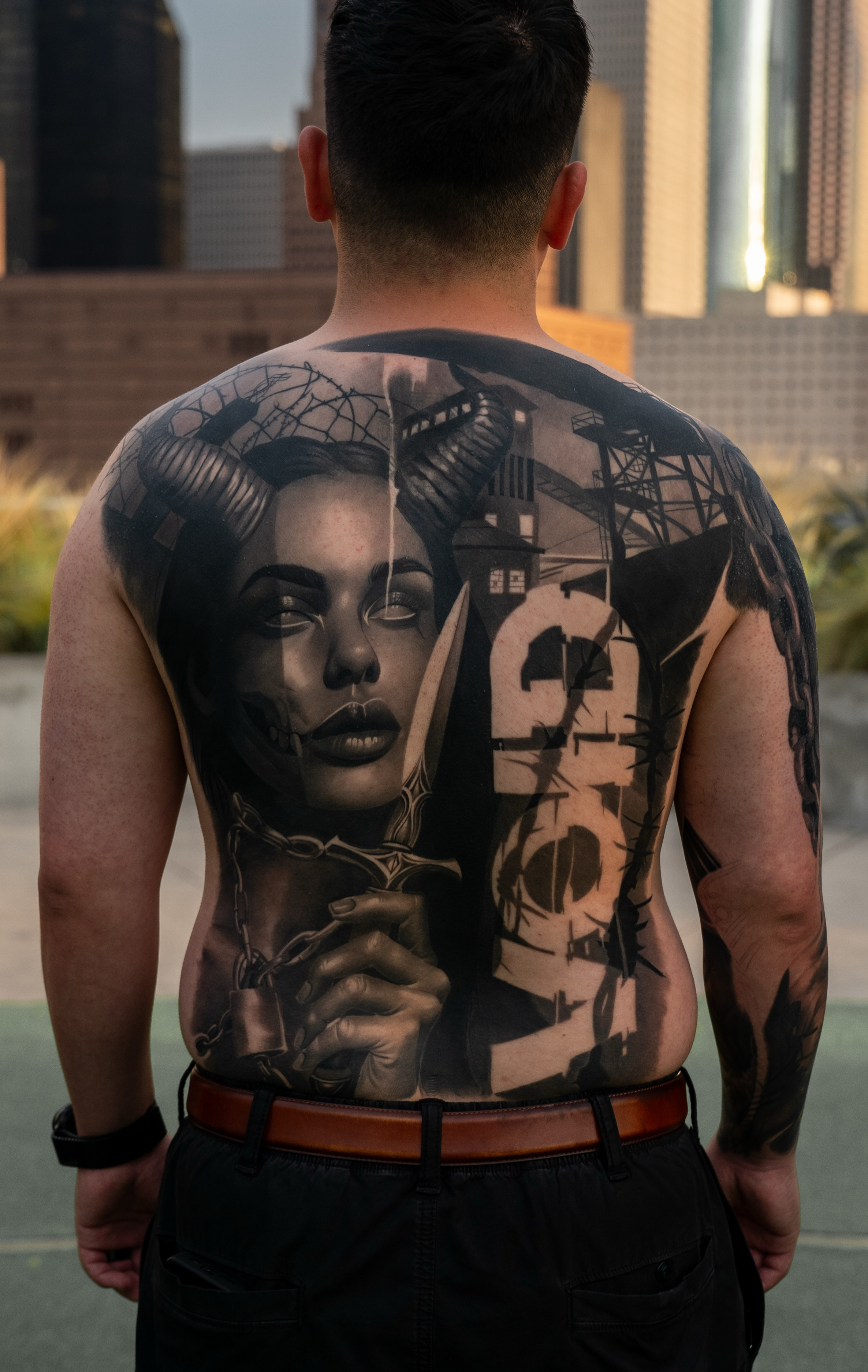 Large dark realism back tattoo