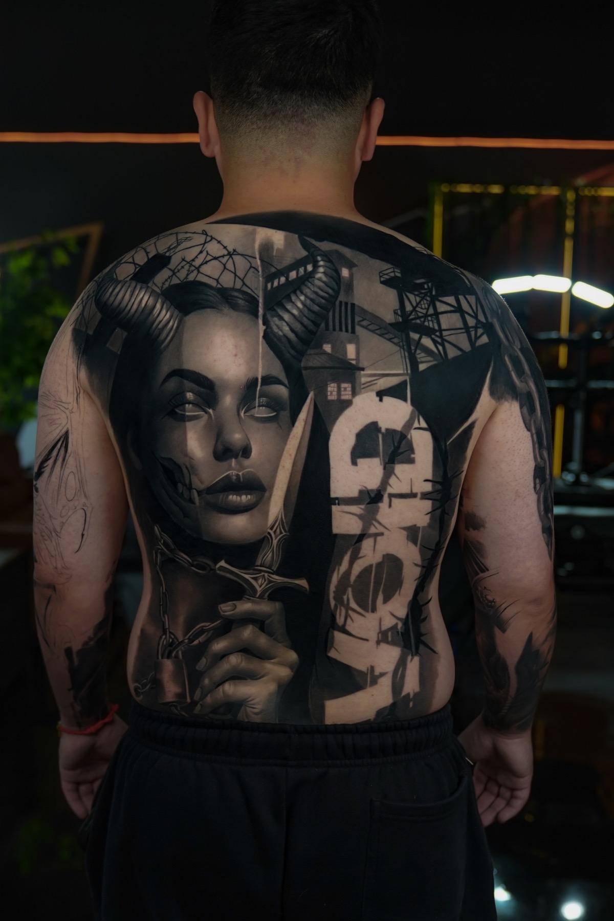 Dark realism full back tattoo by Fábio Guerreiro.