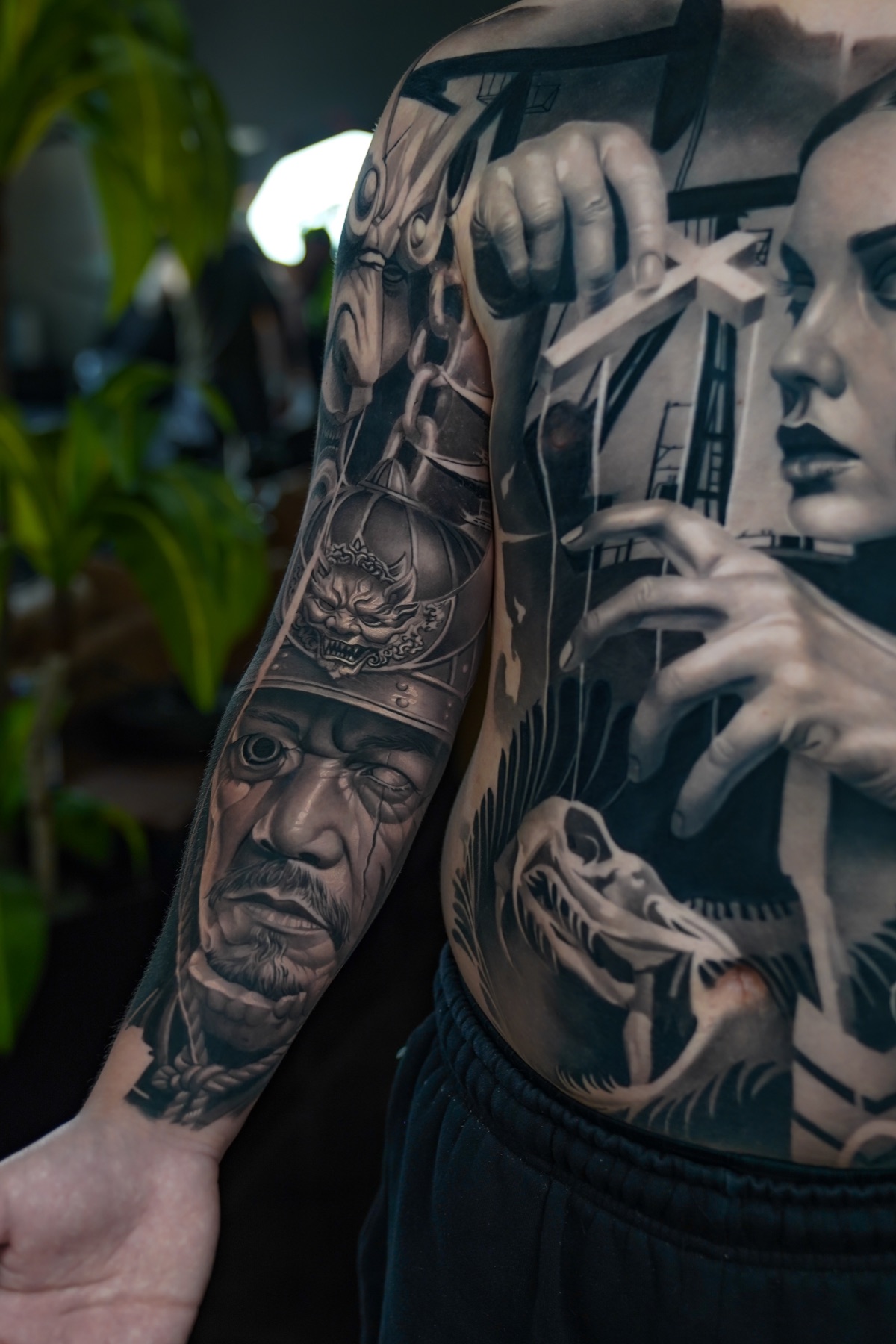 Dark realism torso and sleeve tattoo detail by Fábio Guerreiro.