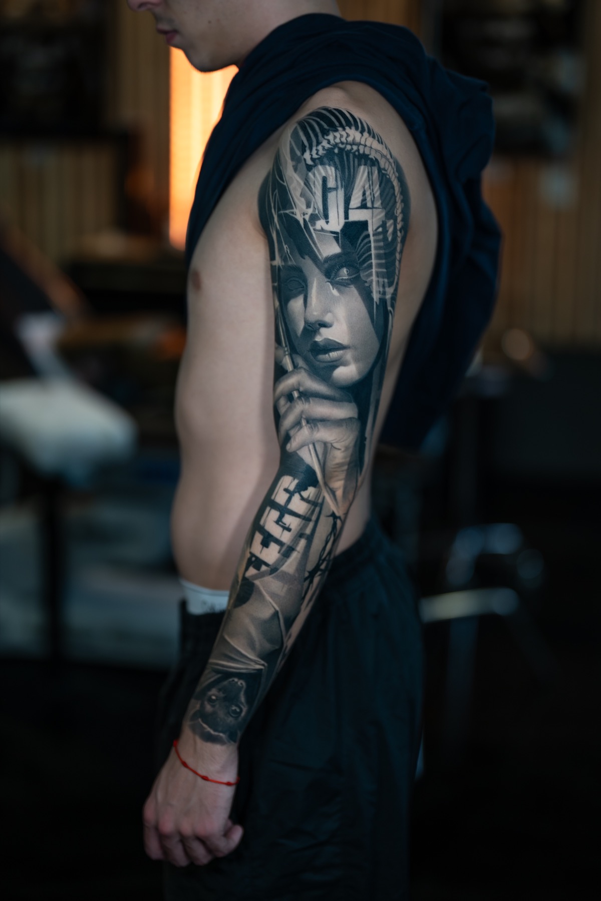 Dark realism sleeve tattoo by Fábio Guerreiro.