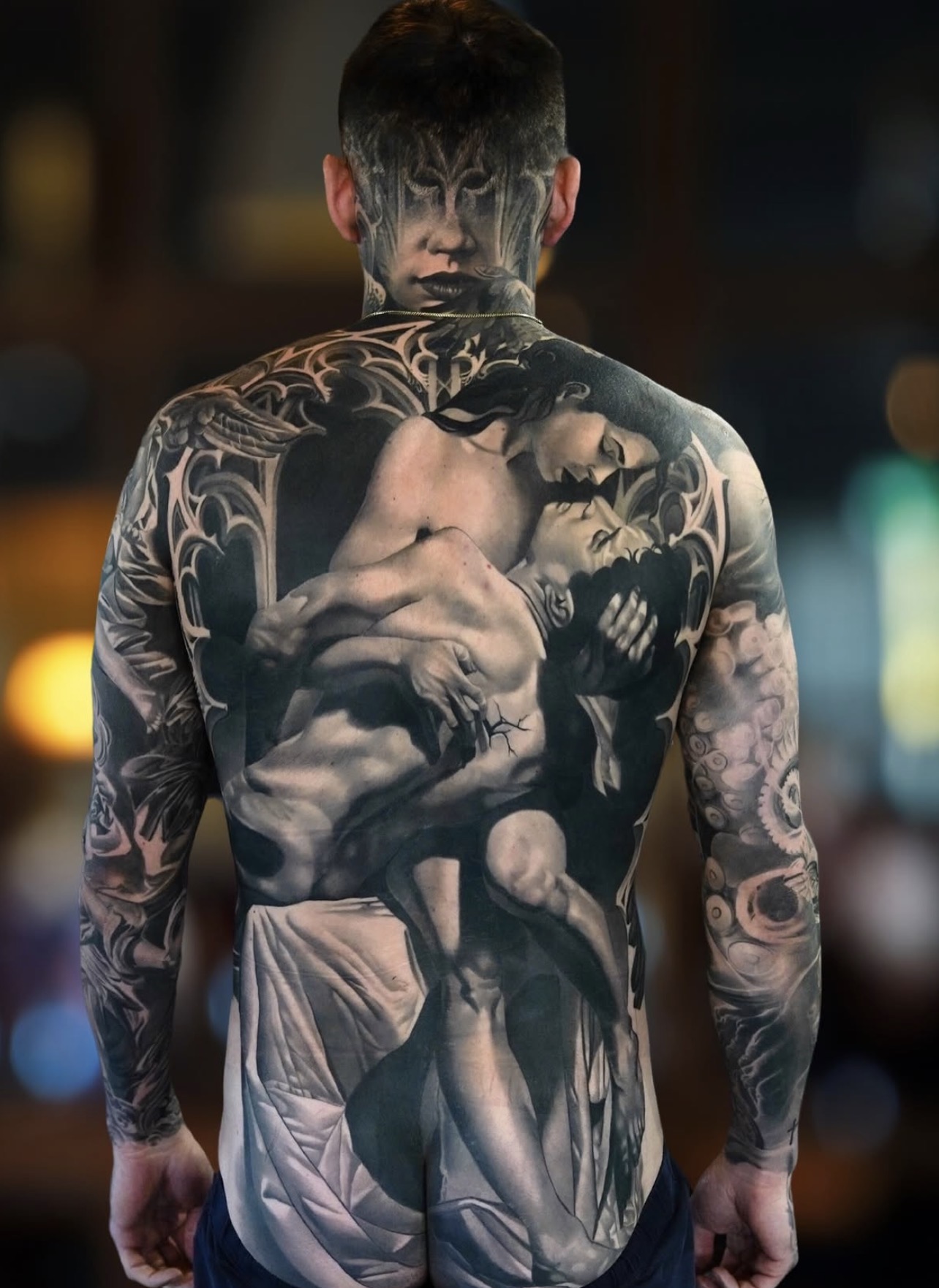 Black and grey back tattoo by Fábio Guerreiro.